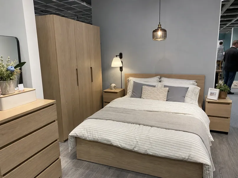 Bedroom lighting fixtures displayed in a furniture retail environment with coordinated bedroom sets