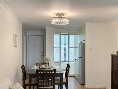 Semi-flush ceiling fixture in a compact apartment dining area