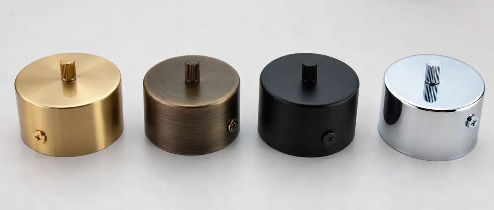 Hotel lighting fixture finish samples showing brushed gold, antique bronze, matte black, and chrome options
