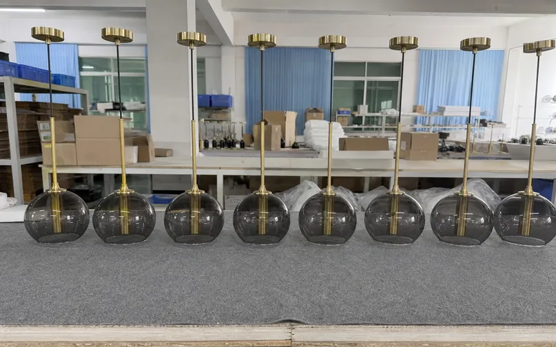 Batch of matching hotel guestroom pendant lights showing finish consistency