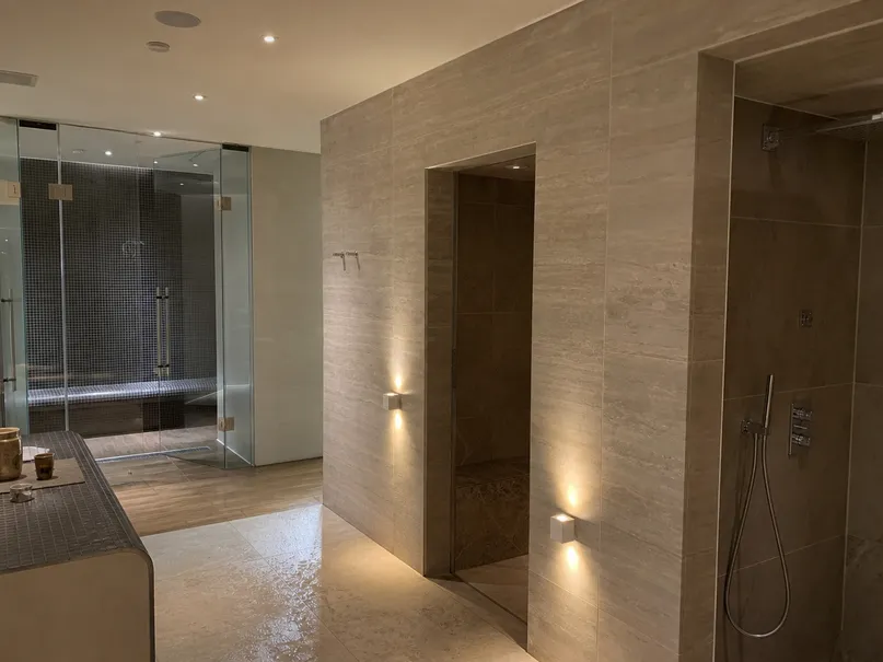 Warm-toned IP-rated lighting fixtures in hotel spa area