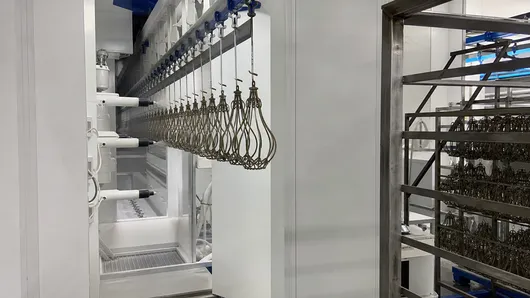 Automated powder coat application for consistent finish across large batches