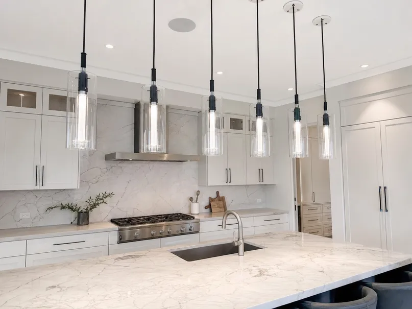 Premium kitchen island pendant lighting in cluster configuration over marble countertop