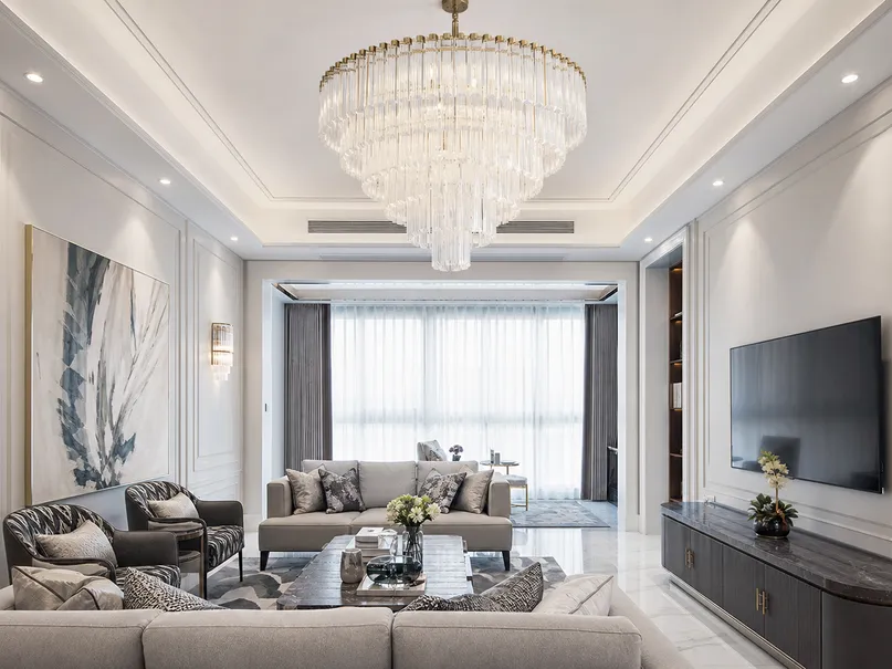 Large-format living room chandelier and layered ambient lighting in luxury residential project