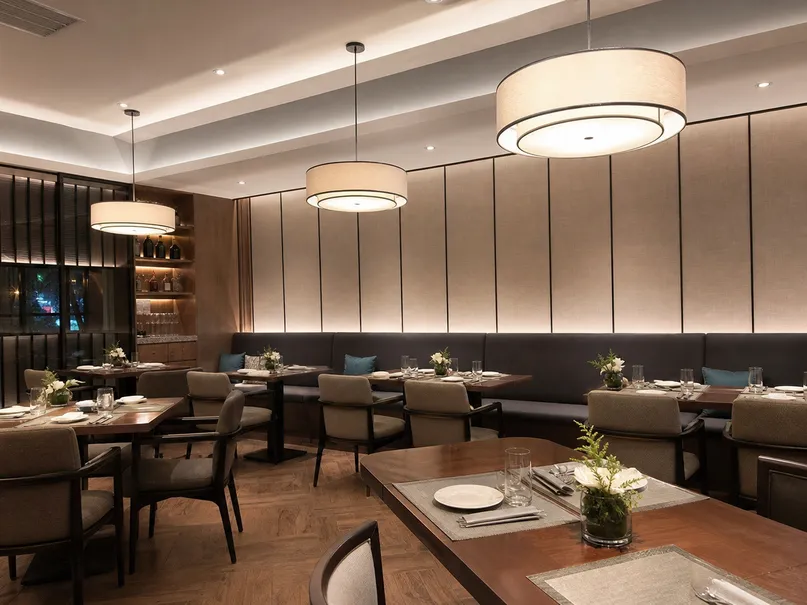 Restaurant pendant lighting over dining tables with warm dimmed ambiance