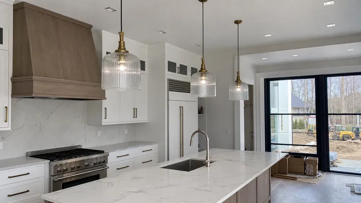 Mid-to-high-end kitchen renovation with modern pendant island lighting installation
