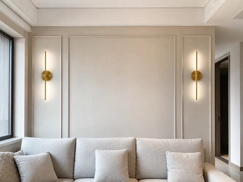 Brushed gold wall sconces flanking a living room feature wall
