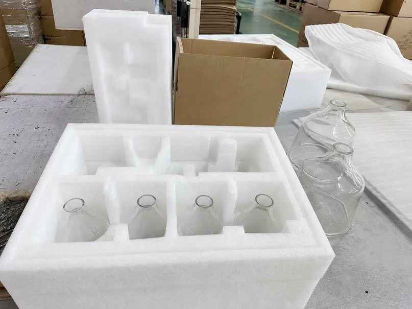EPE foam inserts custom-cut to glass shade geometry for restaurant pendant packaging