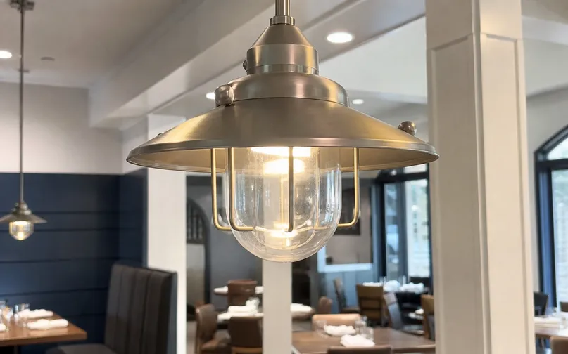 Close-up of a decorative pendant fixture in a commercial restaurant environment showing finish quality