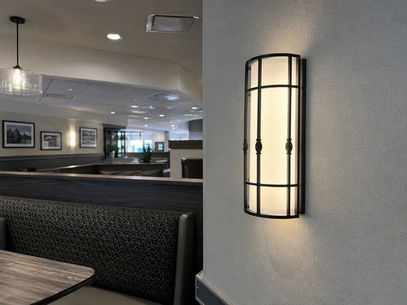 Decorative wall sconce installed near a restaurant booth
