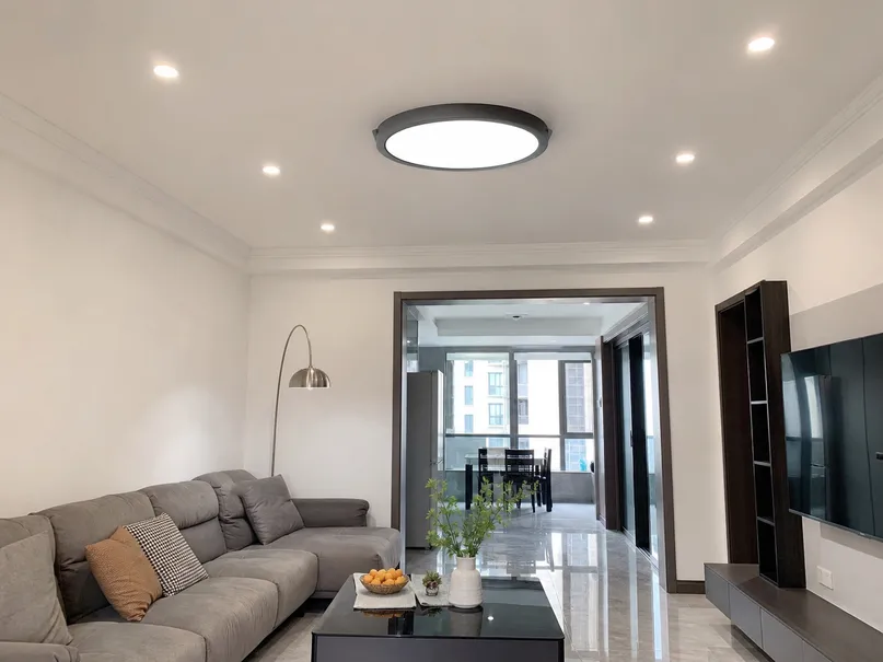 Die-cast aluminum flush mount ceiling fixture installed in villa living room with recessed spotlights