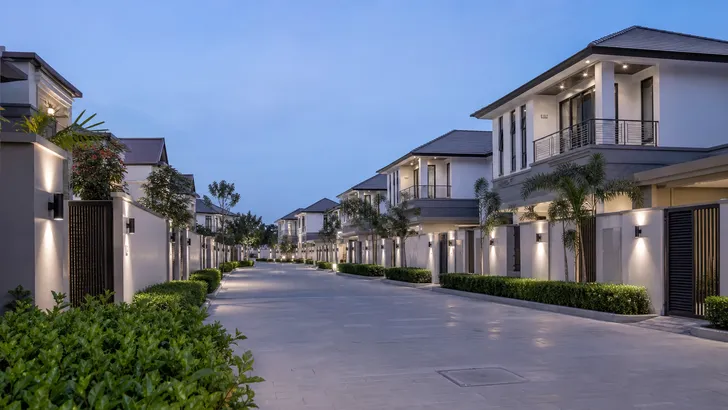 Gated villa community with consistent lighting design across multiple units
