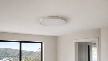 Flush mount ceiling light profile showing housing sitting directly against ceiling surface