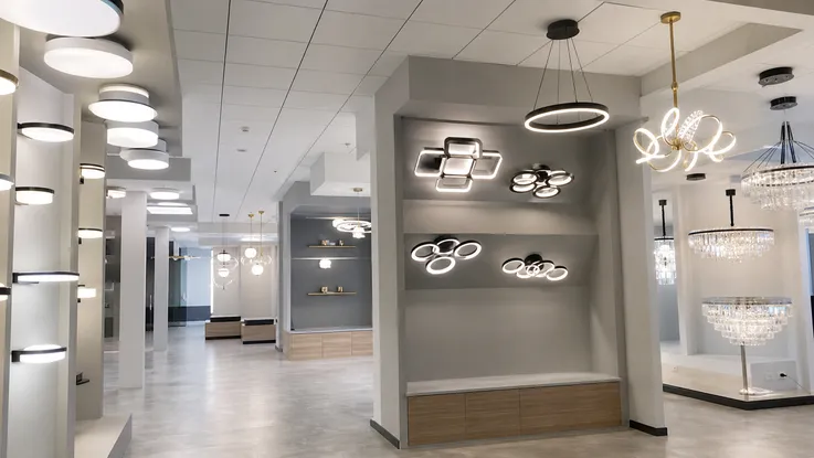 Lighting showroom displaying tiered ceiling fixture product range from functional to luxury