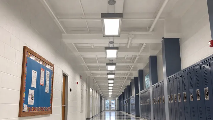 Industrial ceiling lighting in a school corridor