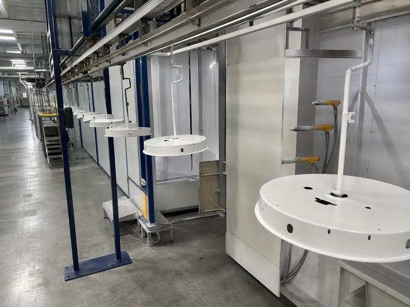 Automated powder coating line showing consistent 60-80μm finish on industrial ceiling fixture housings