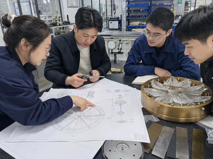 Engineering team reviewing luxury ceiling fixture OEM drawings for production feasibility