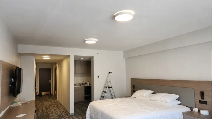 Modern flush mount ceiling fixtures in hotel guest room renovation