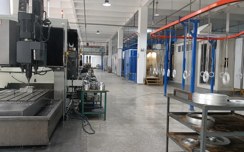 Dedicated production line for modern ceiling lighting fixtures showing CNC machining and powder coating stations