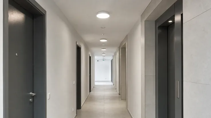 Modern ceiling fixtures installed in multi-unit residential development corridor