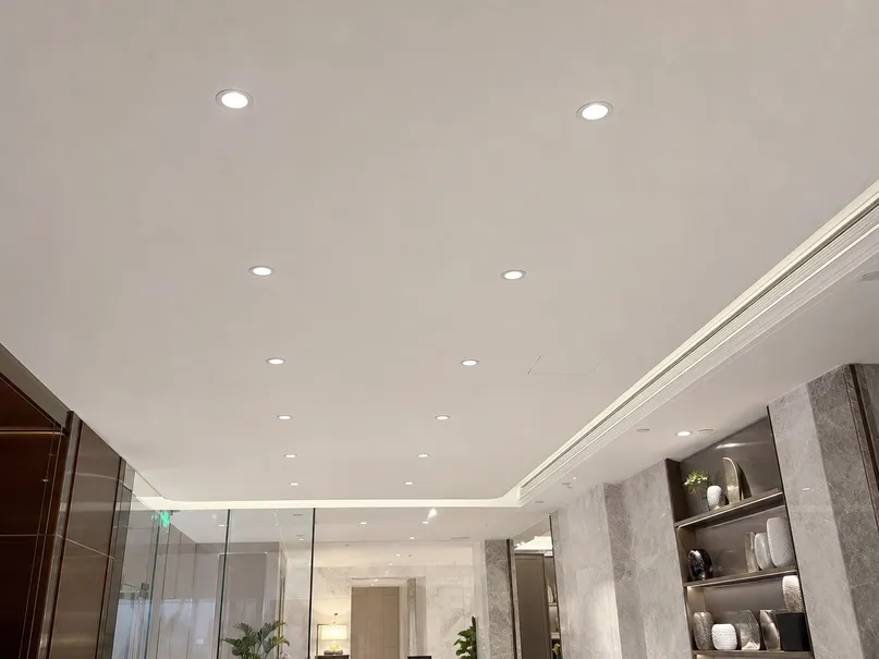 Recessed ceiling lighting fixtures installed in a commercial hospitality project showing flush trim ring alignment