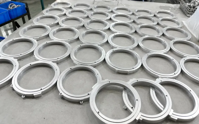 CNC-machined ADC12 aluminum trim rings showing dimensional consistency across a production batch