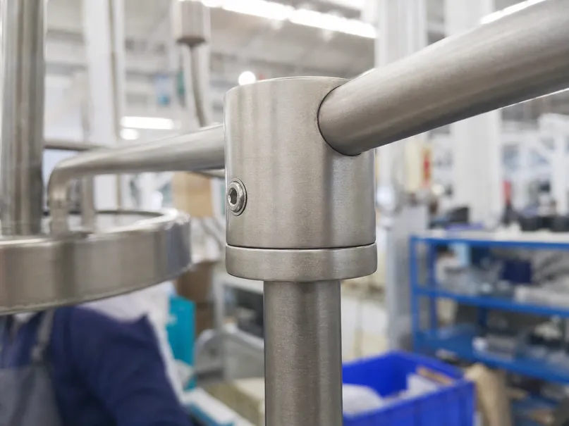 Close-up of die-cast aluminum arm joint showing precision tolerances on chandelier pendant fixture