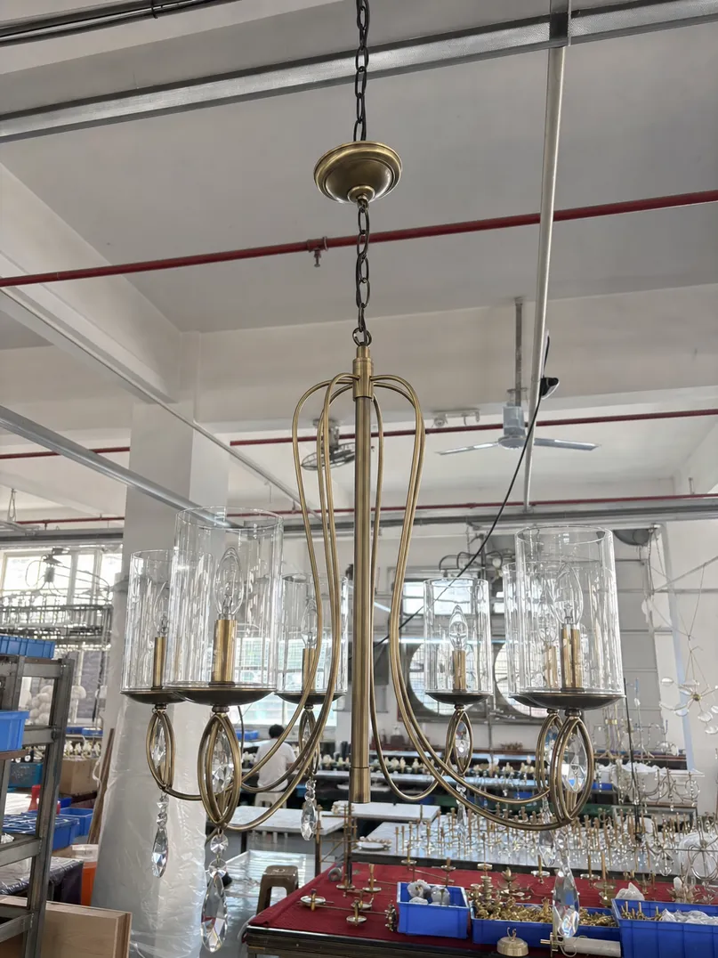 Chandelier pendant lighting fixture with multi-arm decorative metalwork suspended from single canopy