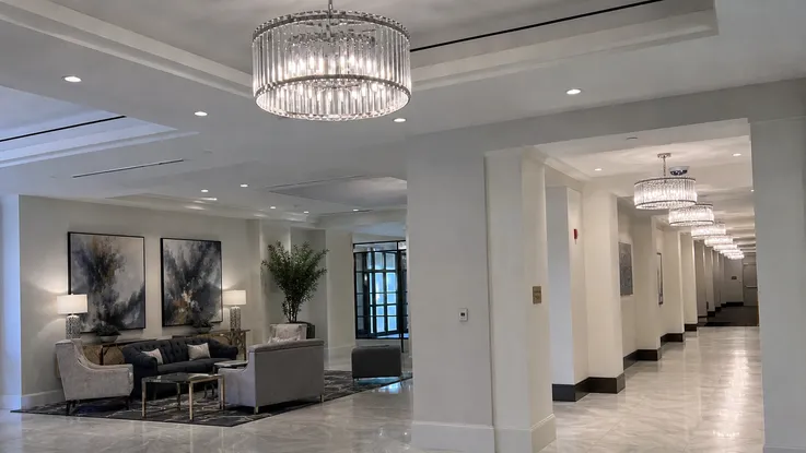Chandelier pendant lighting installed in hotel lobby and corridor spaces