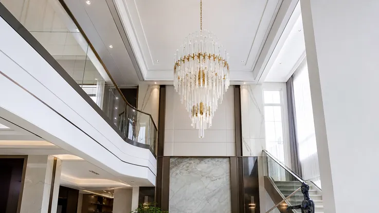 Chandelier pendant lighting in luxury residential double-height living room