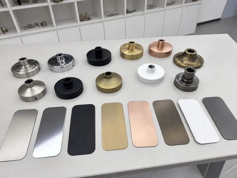 Array of custom finish samples showing different electroplating and powder coating options for chandelier pendants