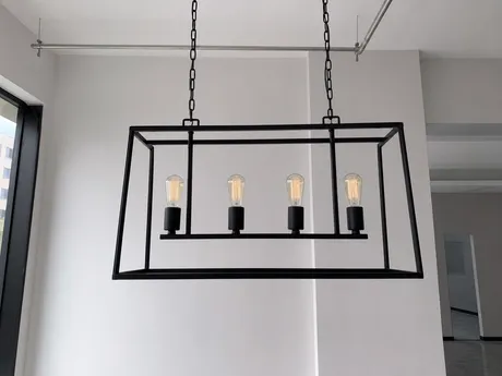 Minimalist modern chandelier with geometric metal frame and exposed bulbs