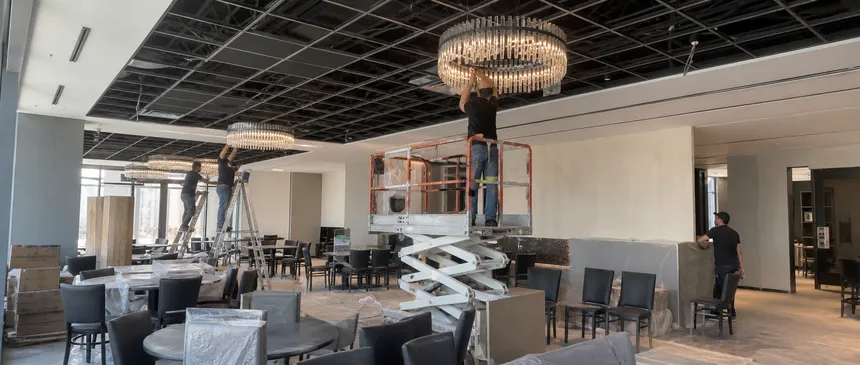 Chandelier installation in commercial restaurant group interior project