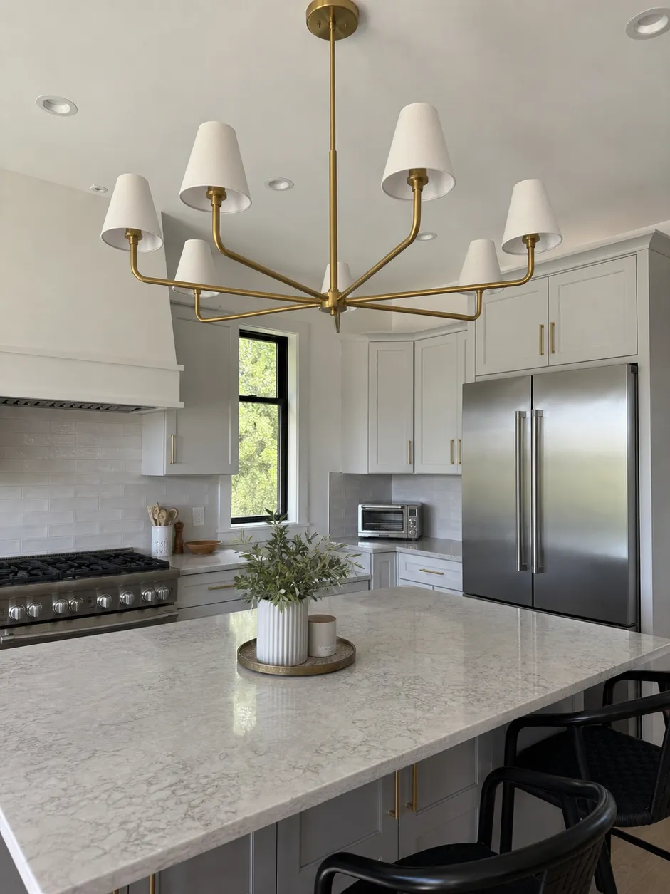 Kitchen chandelier lighting installed in a modern kitchen environment showing brushed gold finish and multi-arm configuration