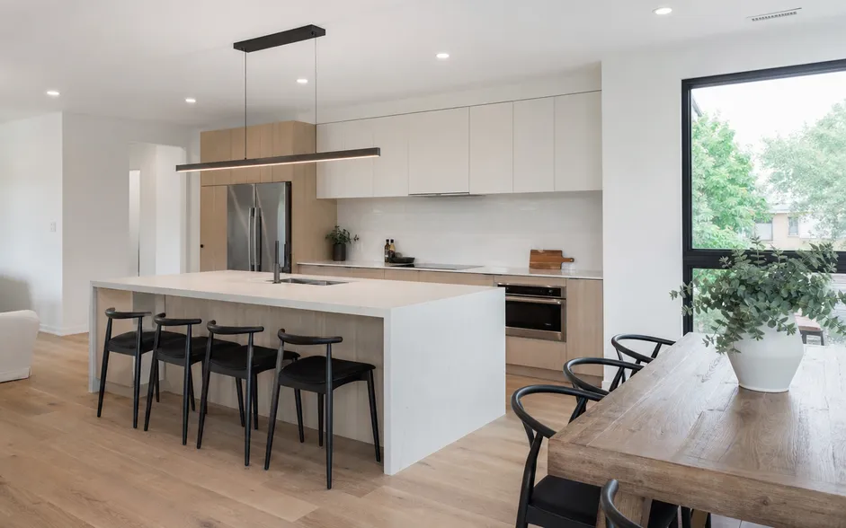 Linear dining chandelier over kitchen island in open-plan residential layout