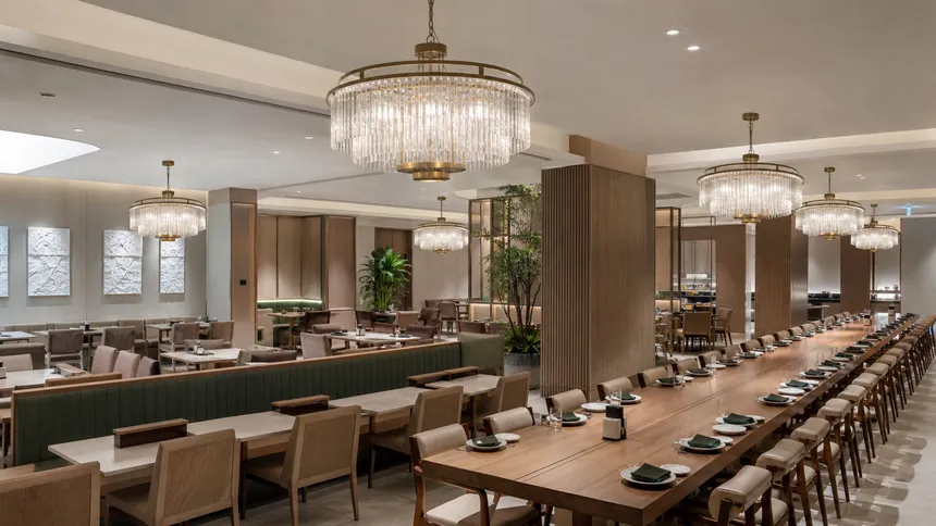 Consistent luxury chandelier installations across a restaurant chain interior with brand-environment lighting
