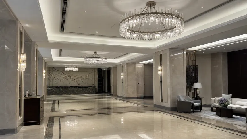 Luxury chandeliers installed in a hotel lobby environment showing consistent finish across multiple fixtures