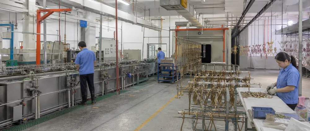 In-house surface finishing production line for luxury chandelier components including electroplating, powder coating, and PVD stations