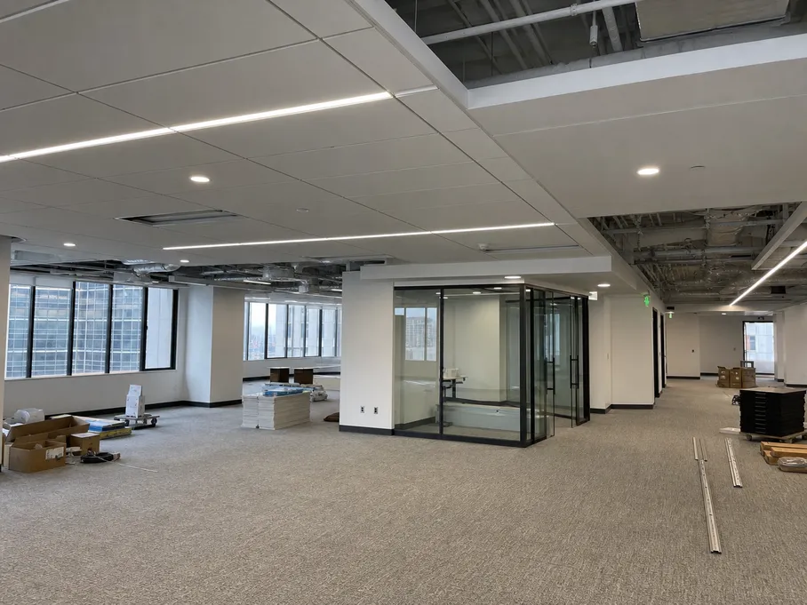 Recessed downlights and linear profiles installed across a commercial office floor plate