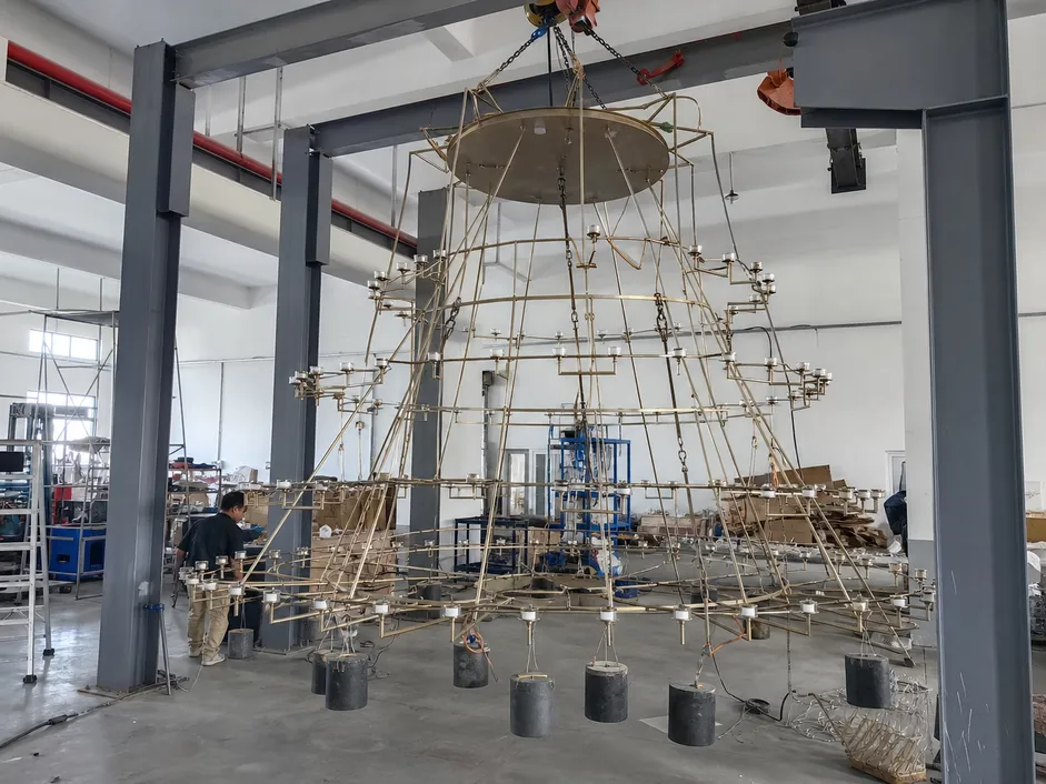 Large-format multi-tier chandelier for hotel atrium installation with load-tested frame