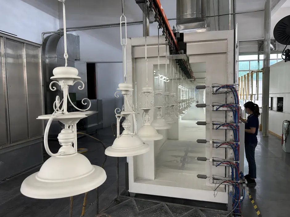 Automated powder coating production line applying consistent 60-80μm finish thickness to decorative lighting fixtures
