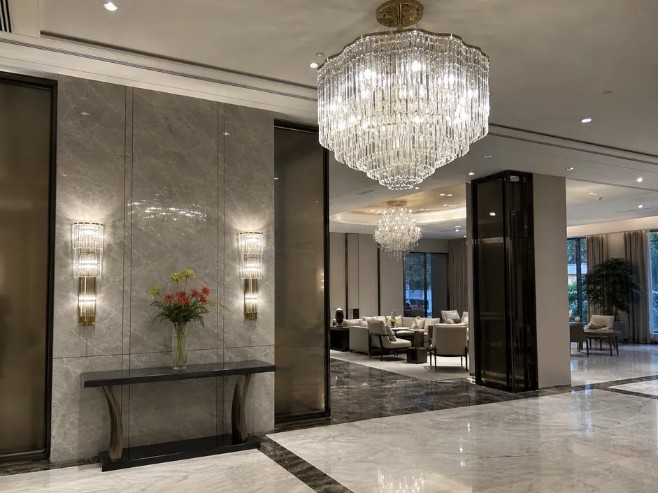 Premium decorative chandeliers and sconces in a luxury residential development lobby