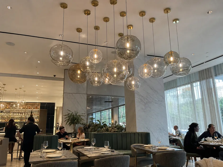 Decorative pendant cluster lighting in a modern restaurant interior creating brand atmosphere