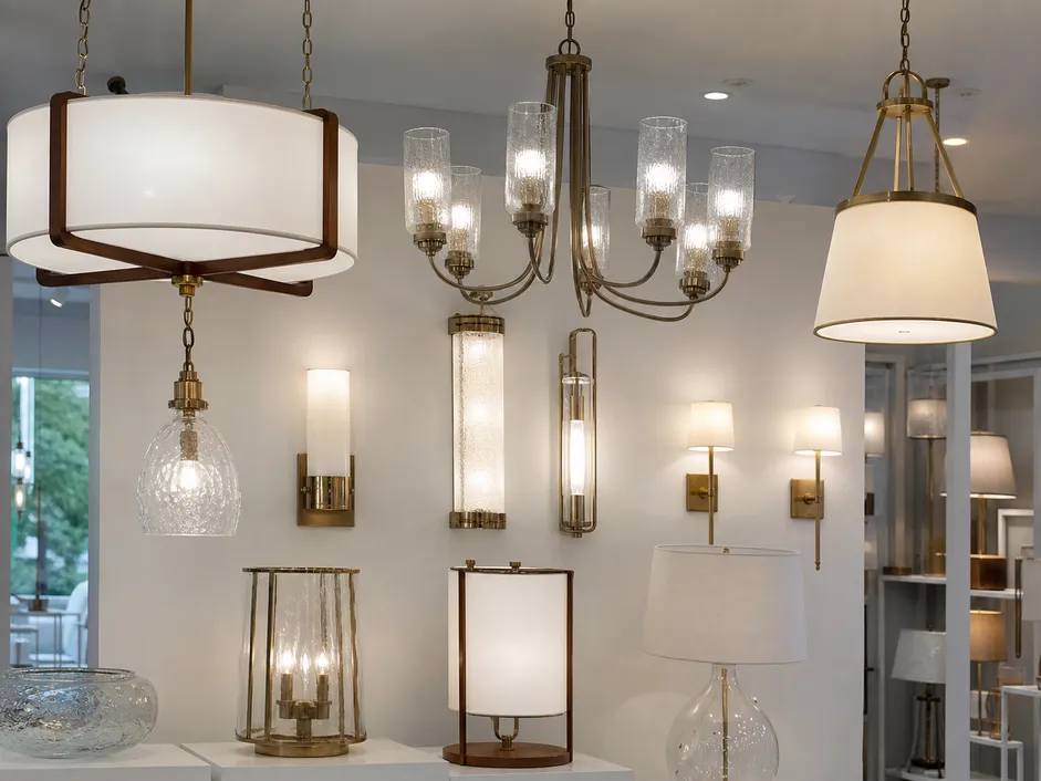 Decorative lighting collection featuring pendants, wall sconces, and chandeliers with ornamental glass shades and mixed material detailing