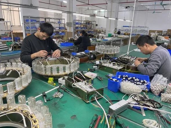LED driver integration and electrical assembly station for luxury lighting fixtures