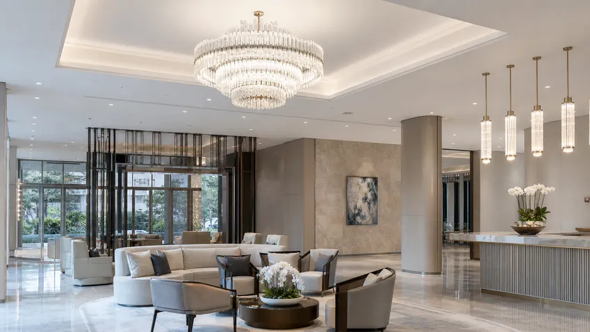 Luxury decorative lighting installed in a hotel lobby environment showing chandelier and pendant fixtures