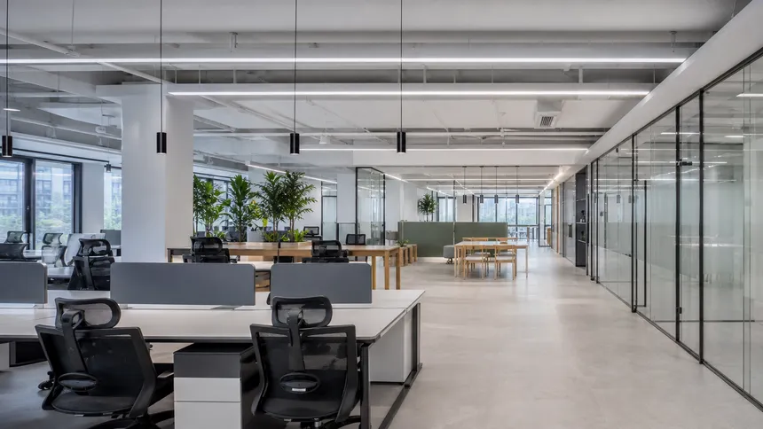 Co-working space with minimalist ceiling lighting and pendant configurations