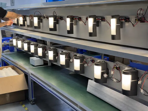 Wall sconce luminaires undergoing 100% aging burn-in test on production line