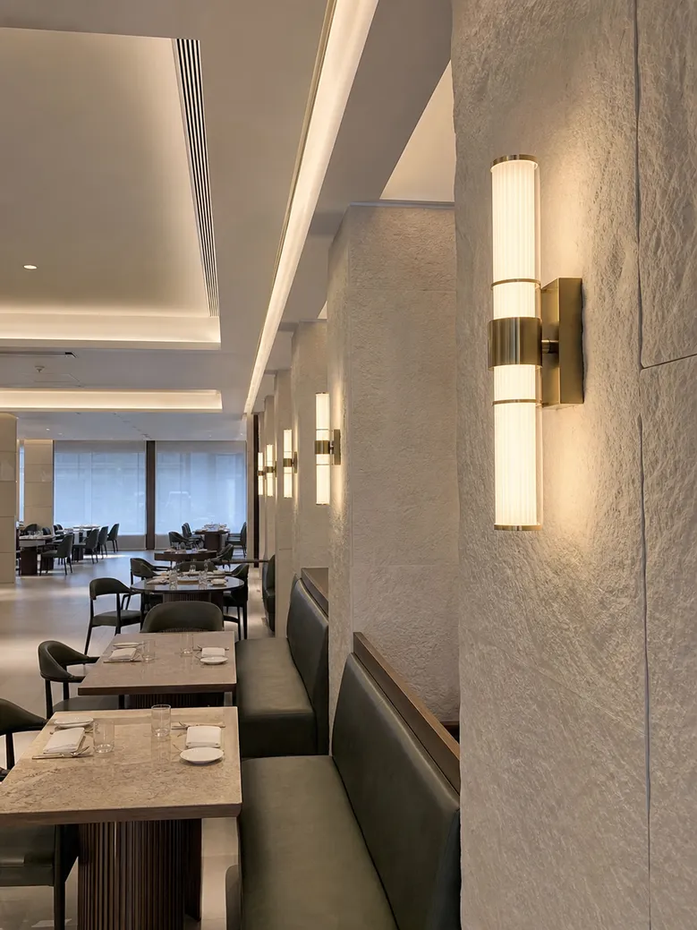 Design-forward custom wall sconces installed in restaurant interior fit-out