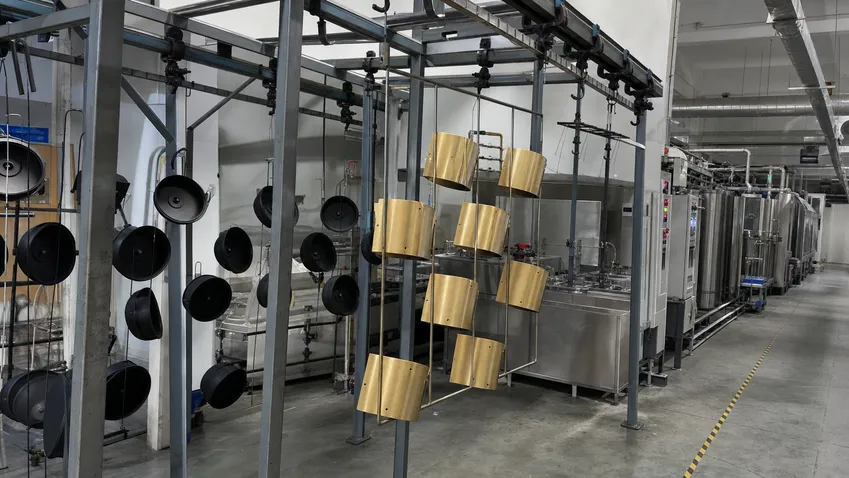 Automated powder coating and PVD finishing line for wall sconce housings